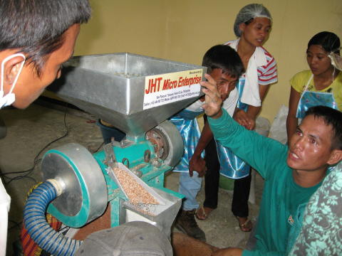 Demonstrating the adjustments on the rice mill